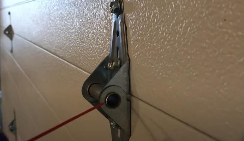lubricating a garage door hinge to reduce noise
